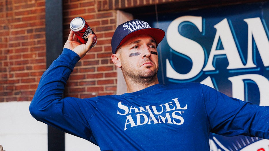 Alex Premran throws beer in a box