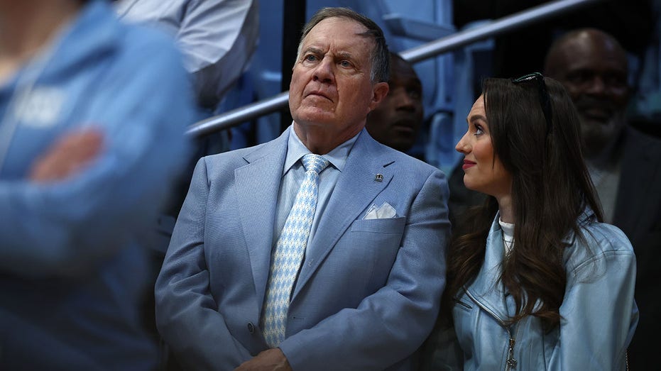 North Carolina Tar Heels football head coach Bill Belichick and his girlfriend Jordon Hudson during a football game in North Carolina.