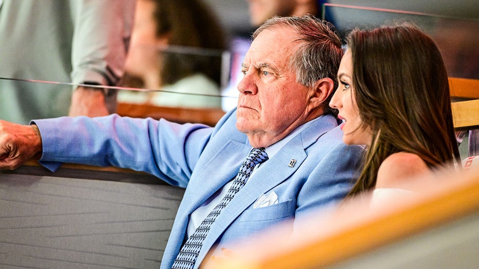 Head coach Bill Belichick of the North Carolina Tar Heels and Jordon Hudson attend Game Two of the First Round of the 2025 Stanley Cup Playoffs