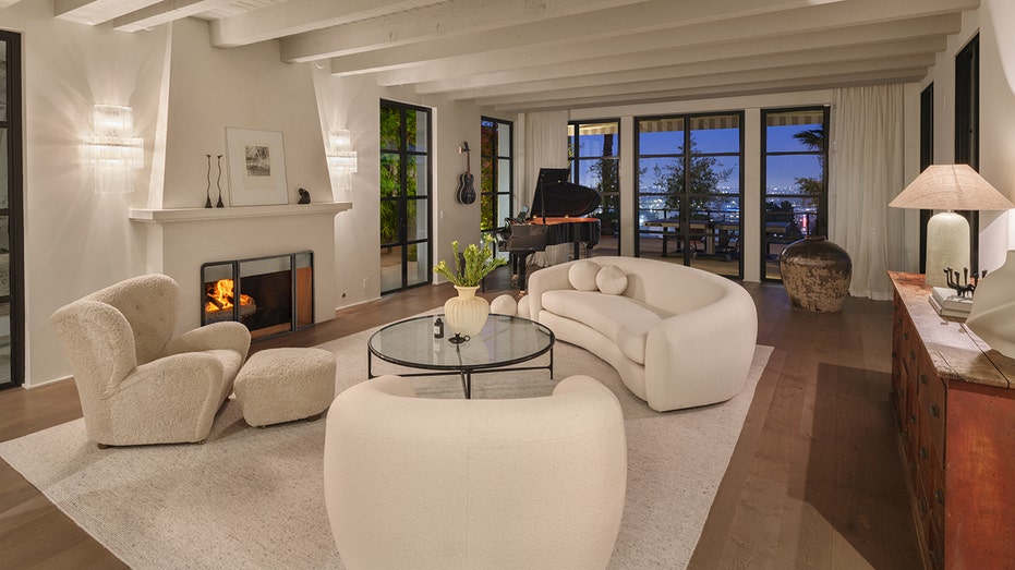 The living room features a wood-burning fireplace and access to the backyard.