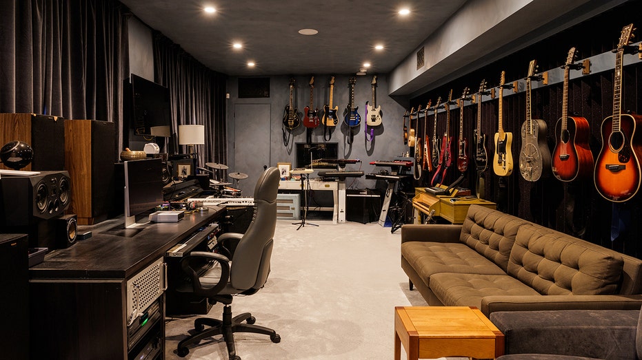 An office with guitars lining the walls.