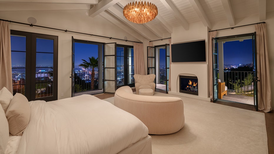 The primary bedroom features access to an outdoor terrace as well as a fireplace.
