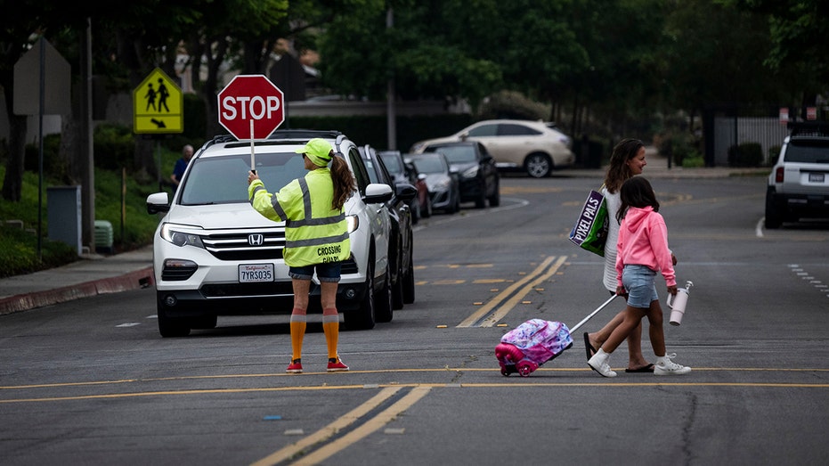 CA students walk to school in crosswalk