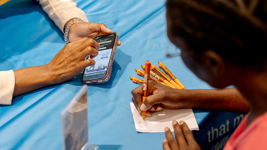 Chicago job fair attendee writes down information