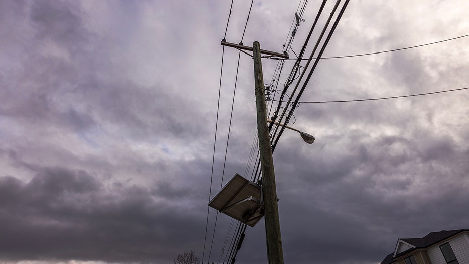 Close-up view of high-voltage power lines running on wooden poles alongside a street in New Jersey. USA.