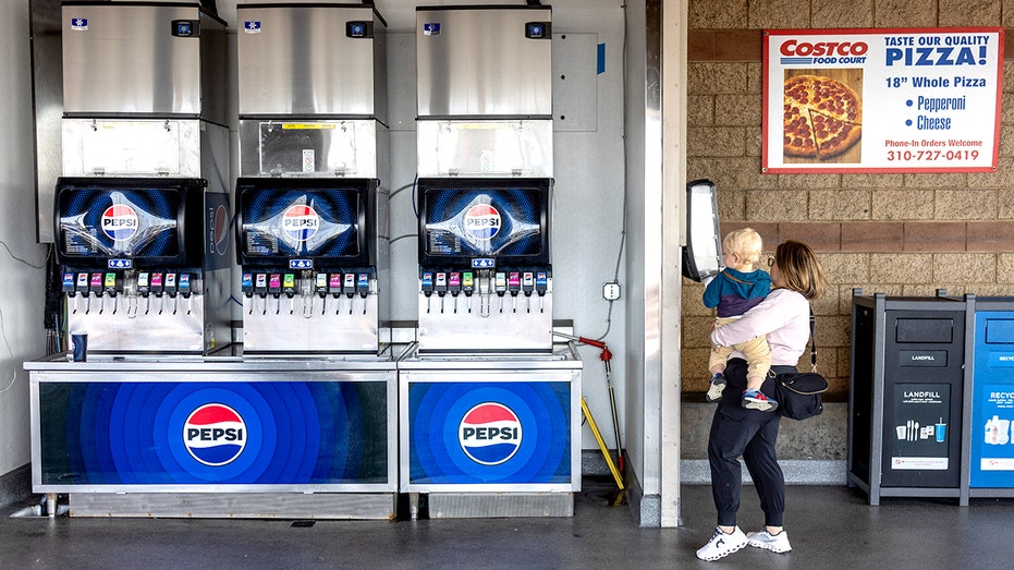 A woman with a child is seen in the food court of a Costco warehouse on April 4, 2025,
