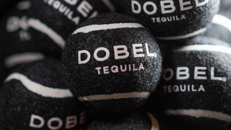 A shot of Dobel Tequila branded tennis balls. 