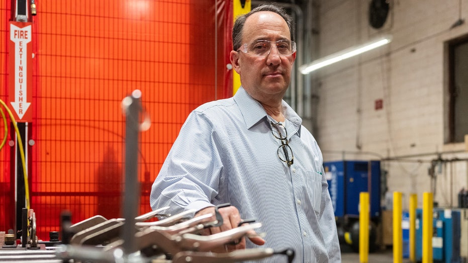 Drew Greenblatt stands inside a factory for Marlin Steel