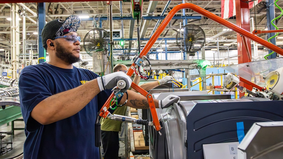 A GE employee working at a manufacturing plant