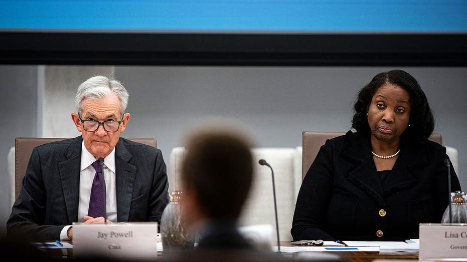 Jerome Powell and Lisa Cook are sitting at a table