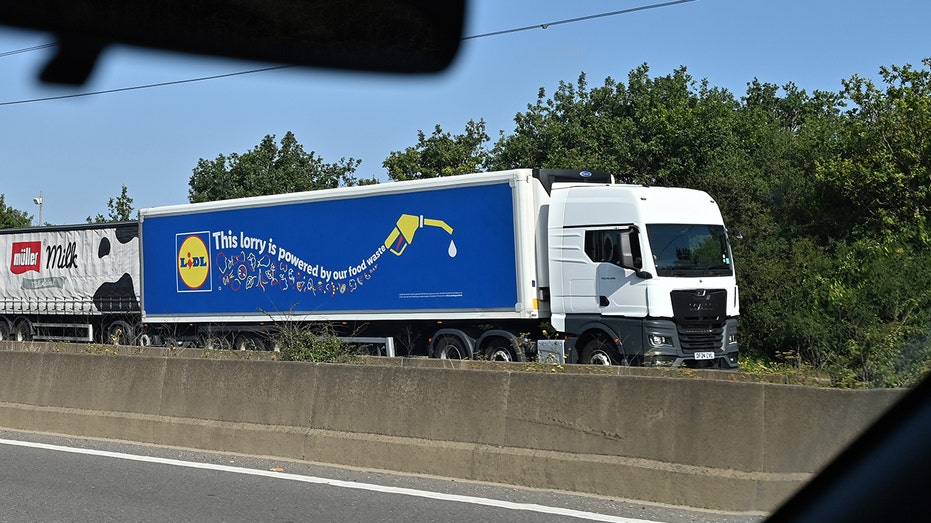A Lidl supermarket branded truck on the highway.