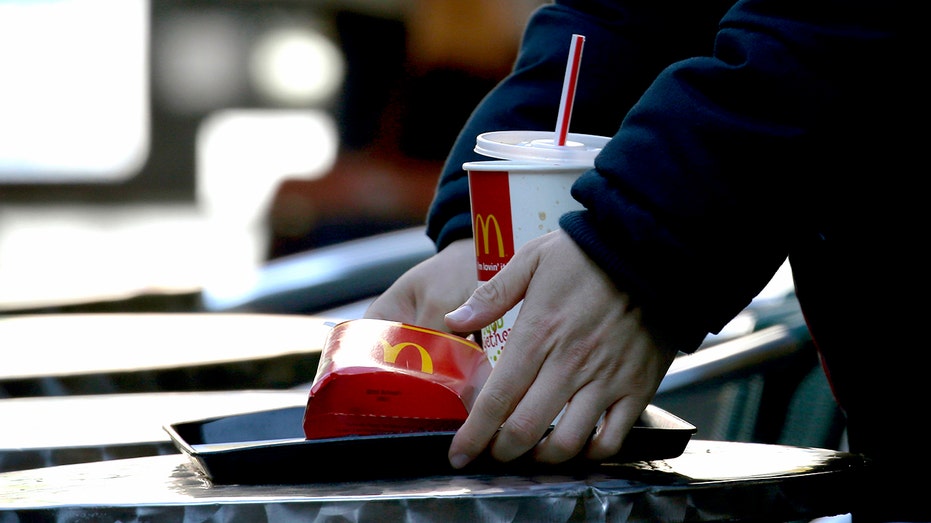 A customer clears away a tray after eating at a McDonald's restaurant in Japan.
