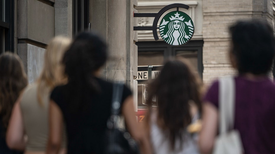 New Yorkers walk past Starbucks