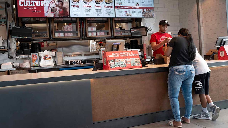 Customers place an order at a Raising Cane's restaurant on June 30, 2025 in Chicago, Illinois.