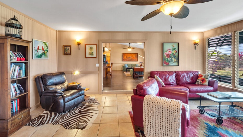 The living room features tiled flooring and a ceiling fan.