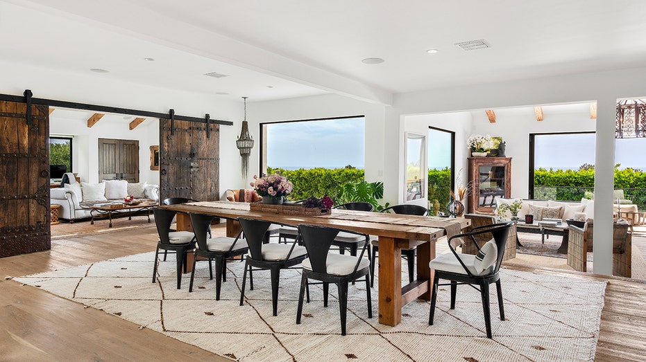 The dining room is found between the kitchen and the living room.