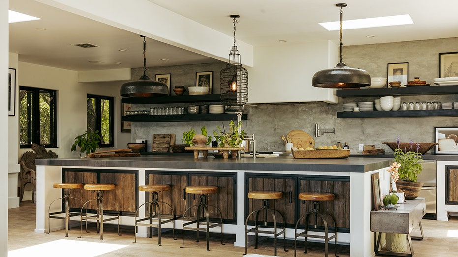 The kitchen features a large eat-in center island as well built-in shelves.