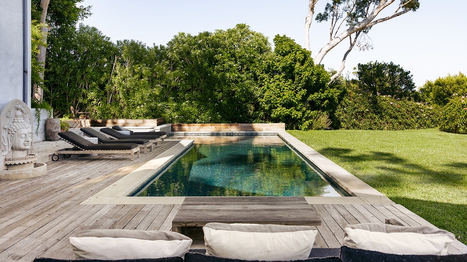 The backyard also features a swimming pool.