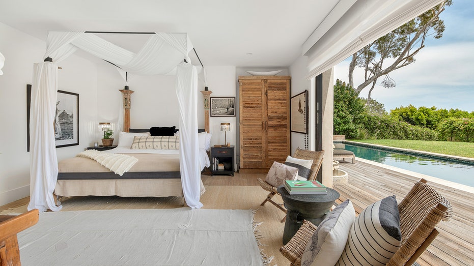The primary bedroom opens up to the backyard and the swimming pool.