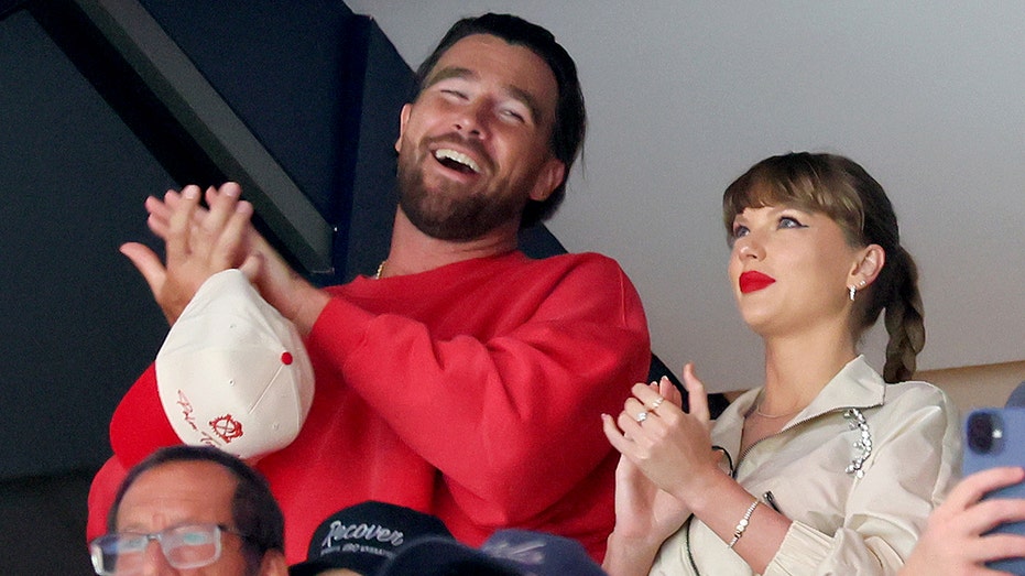 Travis Kelce, left, and Taylor Swift react as the Edmonton Oilers and the Florida Panthers play Amerant Bank Arena on June 12, 2025