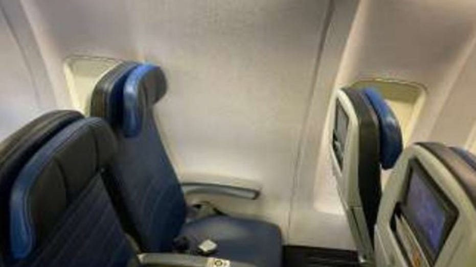 A windowless window seat aboard a United Airlines plane.