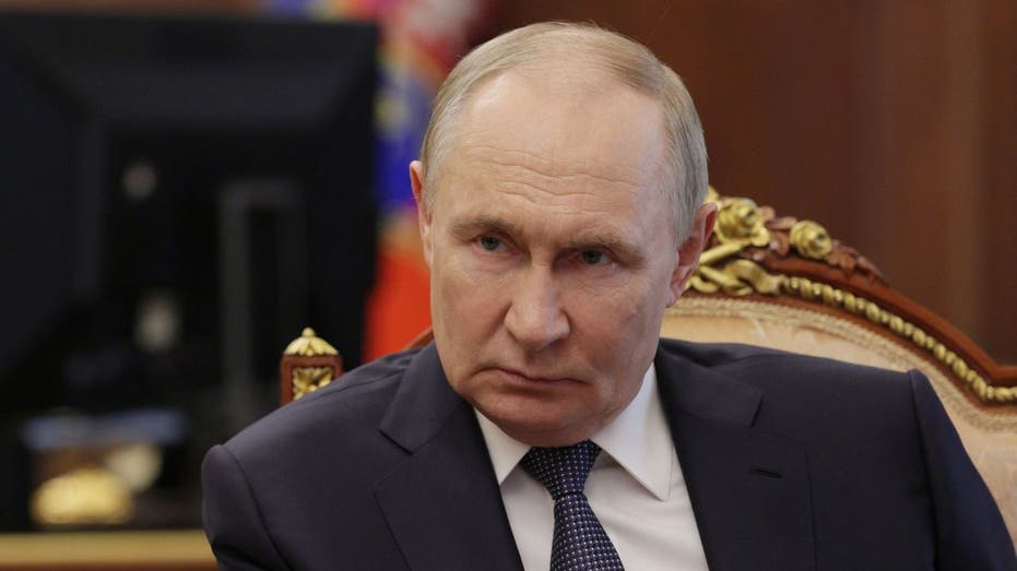 Russian President Vladimir Putin listens during a meeting at the Kremlin