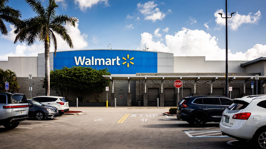 Car park and storefront with logo of a Walmart store and supermarket in Florida City.
