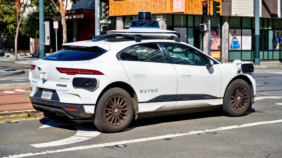 Waymo Jaguar I-PACE autonomous SUV waits at an intersection in San Francisco