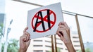 A stock image of a protester holding an anti-AI sign - Fox Business News