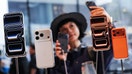 A woman takes a selfie with iPhones inside the Apple store in Beijing's Sanlitun area on Sept. 19, 2025.  - Fox Business News