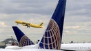 NEWARK, NJ - MARCH 23: A Spirit Airlines jet takes off above two United Airlines airplanes at Newark Liberty Airport on March 23, 2018 in Newark, New Jersey. (Photo by Gary Hershorn/Getty Images) - Fox Business News
