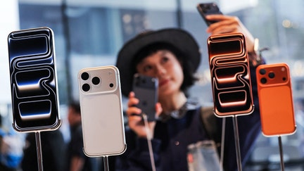 A woman takes a selfie with iPhones inside the Apple store in Beijing's Sanlitun area on Sept. 19, 2025.  - Fox Business News