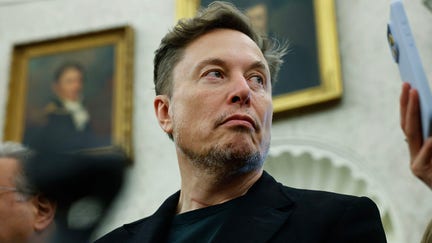 WASHINGTON, DC - MAY 21: Elon Musk listens as reporters ask U.S. President Donald Trump and South Africa President Cyril Ramaphosa questions during a press availability in the Oval Office at the White House on May 21, 2025 in Washington, DC. Relations between the two countries have been strained since Trump signed an executive order in February that claimed white South Africans are the victims of government land confiscation and race-based “genocide,” while admitting some of those Afrikaners as refugees to the United States. Trump also halted all foreign aid to South Africa and expelled the country’s Ambassador to the U.S., Ebrahim Rasool. (Photo by Chip Somodevilla/Getty Images) - Fox Business News