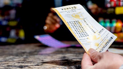 AUSTIN, TEXAS - SEPTEMBER 04: A person holds a Powerball lottery ticket they purchased at the Brew Market &amp; Cafe on September 04, 2025 in Austin, Texas. The Powerball Jackpot has grown to $1.7 billion, positioning it as the third largest prized jackpot in U.S. lottery history. (Photo by Brandon Bell/Getty Images) - Fox Business News