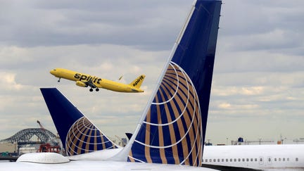 NEWARK, NJ - MARCH 23: A Spirit Airlines jet takes off above two United Airlines airplanes at Newark Liberty Airport on March 23, 2018 in Newark, New Jersey. (Photo by Gary Hershorn/Getty Images) - Fox Business News