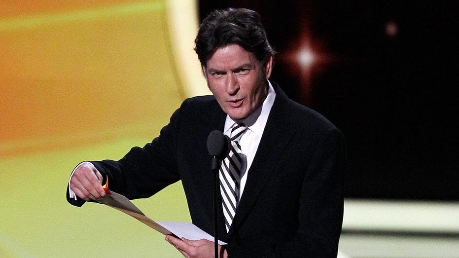 Presenter Sheen announces the winner of the award for outstanding lead actor in a comedy series at the 63rd Primetime Emmy Awards in Los Angeles