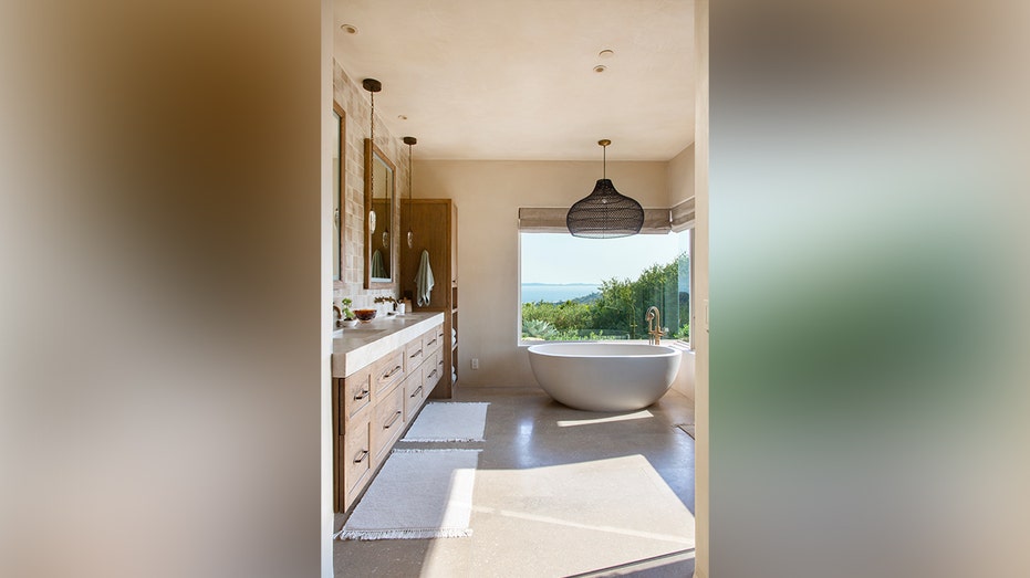 The ensuite bathroom includes a long vanity as well as a soaking tub.