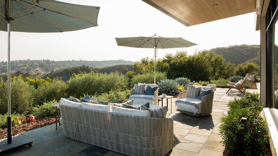 The property also includes an outdoor lounge area with views of the ocean.