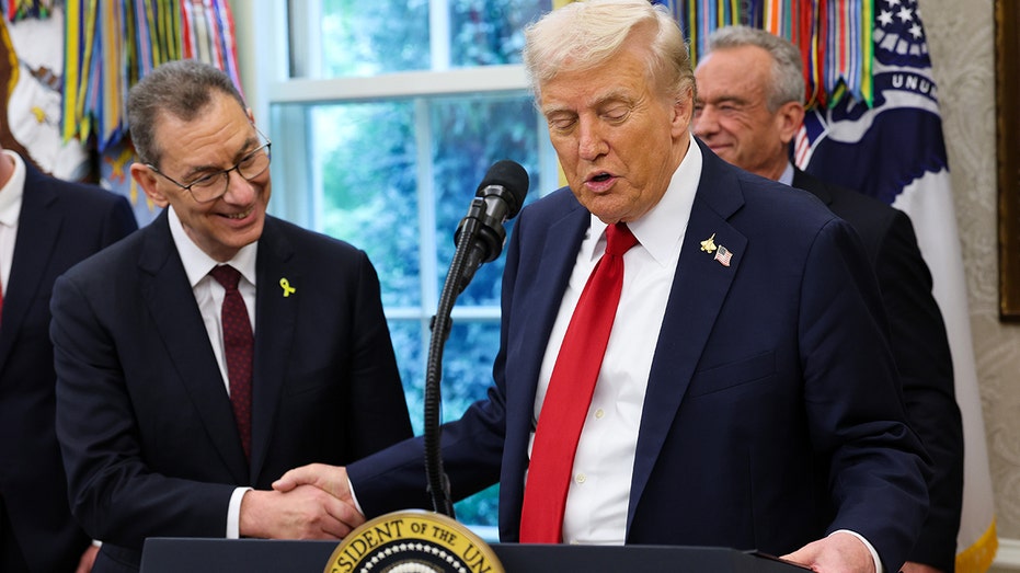 President Donald Trump shakes hands with Pfizer CEO Albert Bourla