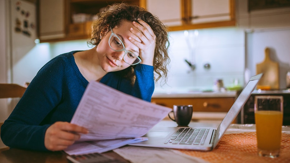 Young woman is stressed over finances
