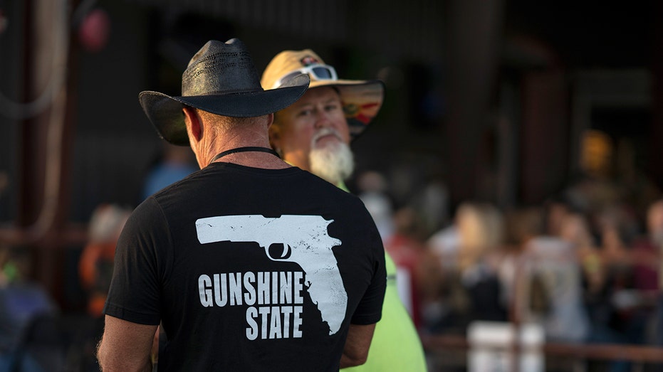 Man wears "Gunshine State" shirt