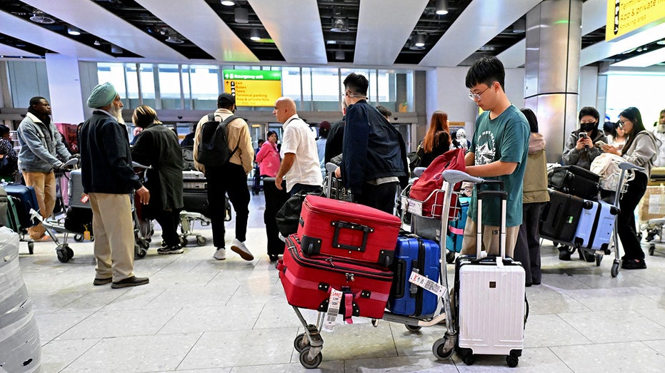 Travellers wait in the terminal at Heathrow Airport, west of London on September 20.