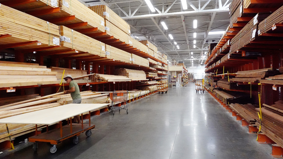 A customer shops in the lumber section of a Home Depot store