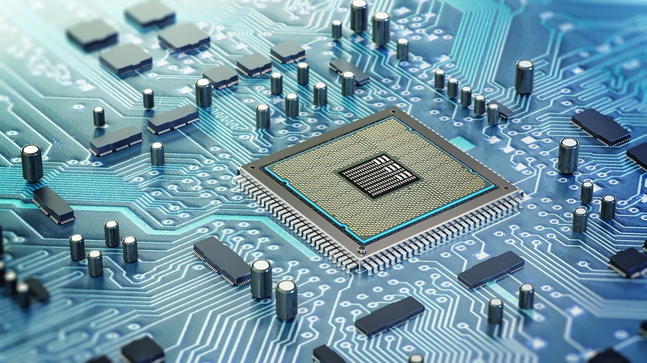 Detailed architecture of a computer chip nestled on a circuit board. The surrounding electronic components highlight modern technology's complexity and innovation