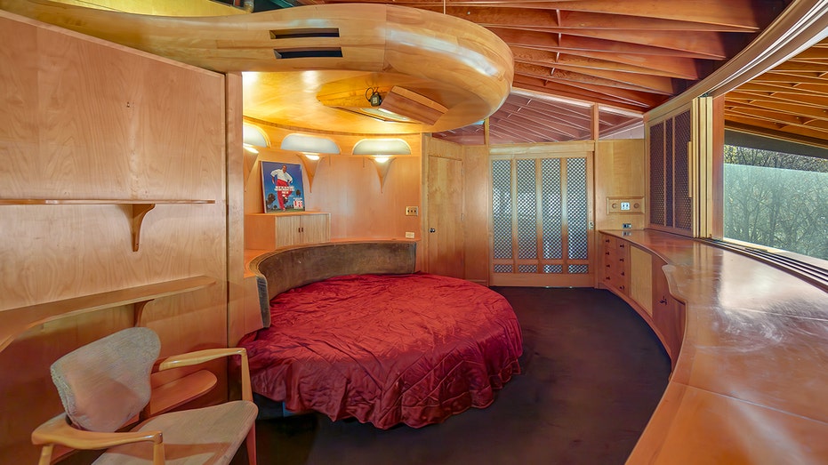 The circular bedroom features wooden beams on the ceiling.