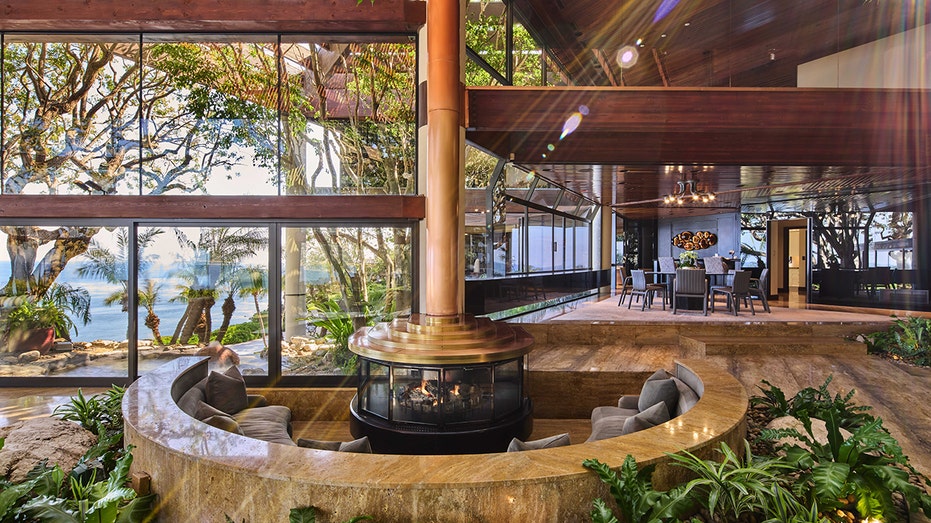 The living room features a fireplace with circular seating around it.
