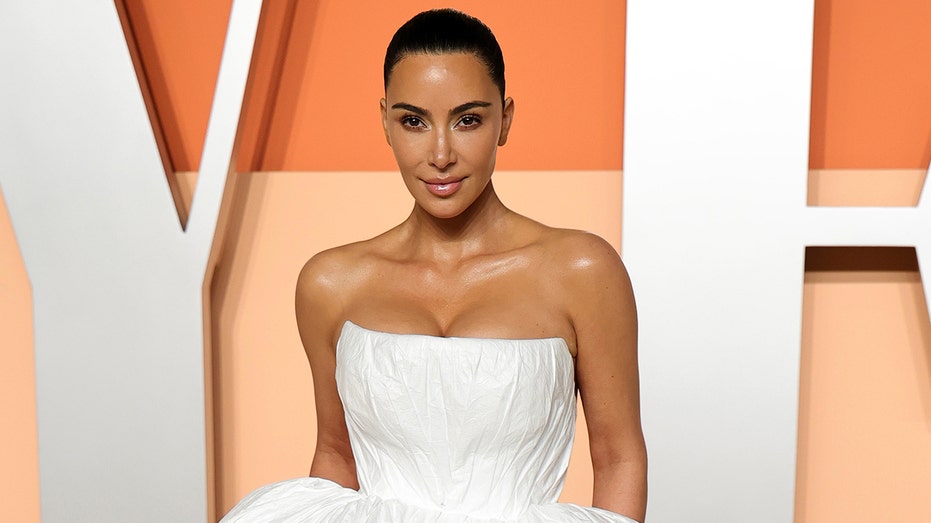 Kim Kardashian in a white dress at the Vanity Fair Oscars party in March 2025.