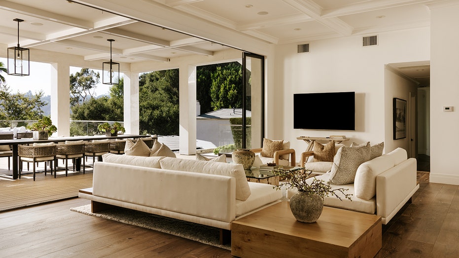 The family room opens up to an outdoor dining room and another lounge area.