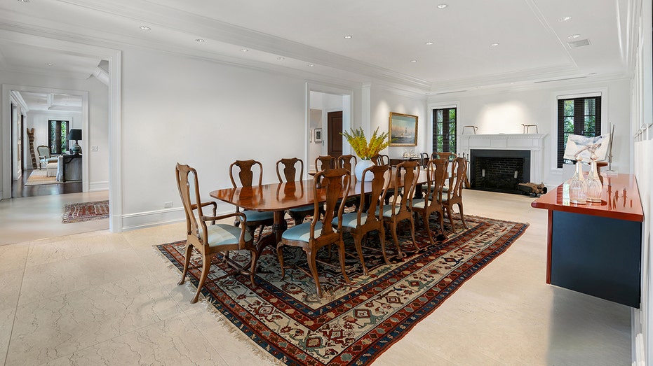 The dining room features a fireplace and a table large enough for 12 diners.