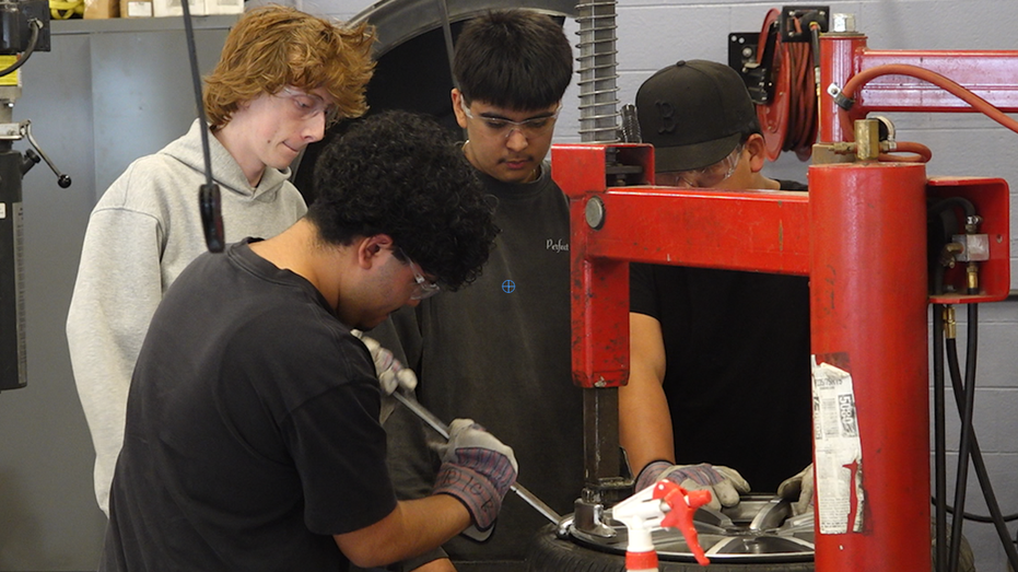 Teenagers working in a skilled trade class